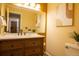 Bathroom featuring a wood vanity, white countertop, decorative mirror, and stylish accents at 10652 W Florida Ave # D, Lakewood, CO 80232