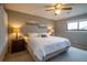 Comfortable bedroom features a ceiling fan, plush bedding, neutral tones, and ample natural light at 10652 W Florida Ave # D, Lakewood, CO 80232