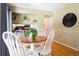 Sunlit dining area with wood floors, seating for four, and adjacent kitchen views at 10652 W Florida Ave # D, Lakewood, CO 80232