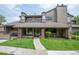 Charming multi-story home with well-maintained lawn, brick accents, and inviting entryway at 10652 W Florida Ave # D, Lakewood, CO 80232