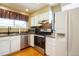 A well-lit kitchen featuring white cabinets, stainless steel appliances, and a granite countertop at 10652 W Florida Ave # D, Lakewood, CO 80232