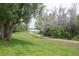 Scenic community pathway with lush greenery leading towards the beautiful lake at 10652 W Florida Ave # D, Lakewood, CO 80232