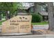 Lake Lochwood Village community sign with lush greenery, offering a covenant-protected neighborhood at 10652 W Florida Ave # D, Lakewood, CO 80232