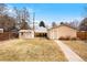 Spacious backyard with green grass, a shed, and a backyard studio with a white door and trim at 1780 Roslyn St, Denver, CO 80220