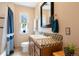 Bathroom with shower-tub combo, mosaic tile countertop, and a large decorative mirror at 1780 Roslyn St, Denver, CO 80220