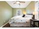 Comfortable bedroom with a ceiling fan and a sun-filled window at 1780 Roslyn St, Denver, CO 80220