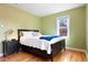 Bedroom featuring a bed with a stylish side table and hardwood floors at 1780 Roslyn St, Denver, CO 80220