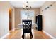 Bright dining room with hardwood floors, a stylish chandelier, and backyard access at 1780 Roslyn St, Denver, CO 80220