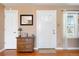 Bright entryway with hardwood floors, a decorative mirror, and a charming side table at 1780 Roslyn St, Denver, CO 80220