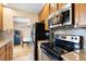 Cozy kitchen featuring stainless steel appliances, wood cabinets, and tile backsplash at 1780 Roslyn St, Denver, CO 80220