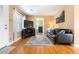 Cozy living room with hardwood floors, a comfortable sofa, and a view to the bedroom at 1780 Roslyn St, Denver, CO 80220