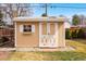 Backyard storage shed with a white door, trim, brick steps, and a small window at 1780 Roslyn St, Denver, CO 80220