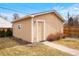 Backyard studio with siding, white trim, one window, a side yard, and a concrete walkway at 1780 Roslyn St, Denver, CO 80220