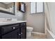 Classic bathroom with a dark wood vanity, white sink, and tiled shower area at 4710 E Louisiana Ave, Denver, CO 80246