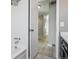 Clean bathroom featuring a tiled shower and a glimpse into the hallway at 4710 E Louisiana Ave, Denver, CO 80246