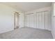 Bedroom with carpeted floor, closets, and neutral wall color at 4710 E Louisiana Ave, Denver, CO 80246