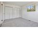 Bedroom with carpeted floor, closets, window providing natural light, and neutral wall color at 4710 E Louisiana Ave, Denver, CO 80246