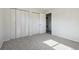 Bedroom with carpeted floor, closets, and laundry room, and neutral wall color at 4710 E Louisiana Ave, Denver, CO 80246
