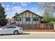 Charming home featuring Tudor style architecture, a fenced yard, and driveway parking at 4710 E Louisiana Ave, Denver, CO 80246