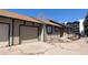 Tan home with green trim and a two-car garage with a concrete driveway at 4710 E Louisiana Ave, Denver, CO 80246