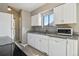 Bright kitchen with white cabinets, granite countertops, and stainless steel appliances at 4710 E Louisiana Ave, Denver, CO 80246