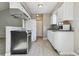 Well-lit kitchen featuring white cabinetry, granite countertops, and modern appliances at 4710 E Louisiana Ave, Denver, CO 80246