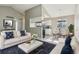 Bright living room featuring vaulted ceilings, an open floor plan, and views into the adjacent kitchen and dining area at 4710 E Louisiana Ave, Denver, CO 80246