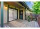 Outdoor patio featuring wooden deck, door to house and door to side yard at 4710 E Louisiana Ave, Denver, CO 80246
