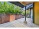 A shaded wooden patio offers a private outdoor living space with mature trees at 4710 E Louisiana Ave, Denver, CO 80246