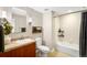 Bathroom with vanity, framed mirror, modern fixtures, and bathtub with shower at 2240 N Clay St # 309, Denver, CO 80211