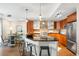 Bright kitchen features a large island with seating, stainless steel appliances, and modern cabinetry at 2240 N Clay St # 309, Denver, CO 80211