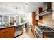 Well-appointed kitchen with stainless steel appliances, spacious island, and adjacent dining area at 2240 N Clay St # 309, Denver, CO 80211