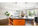 Modern kitchen featuring a breakfast bar with an integrated dishwasher and a large stainless steel sink at 2240 N Clay St # 309, Denver, CO 80211