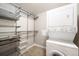 Functional laundry room with stacked washer and dryer, shelving, and storage baskets at 2240 N Clay St # 309, Denver, CO 80211