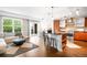 Open-concept living room with hardwood floors, a modern kitchen and a sliding glass door to a balcony at 2240 N Clay St # 309, Denver, CO 80211