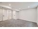 Spacious basement area with neutral carpet, white walls, and an adjacent bathroom at 175 S Emerson St, Denver, CO 80209
