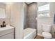 Modern bathroom features a gray patterned tile wall in the shower and new fixtures at 175 S Emerson St, Denver, CO 80209