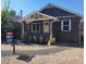 Charming single-story home with dark paint, a well-kept gravel yard, and mature landscaping at 175 S Emerson St, Denver, CO 80209
