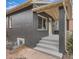 Single-story home featuring dark brick, light trim, and a concrete front porch with steps at 175 S Emerson St, Denver, CO 80209