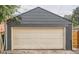Exterior of a detached garage with a traditional panel garage door and neutral paint at 175 S Emerson St, Denver, CO 80209