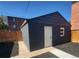 Exterior view of a one-car garage featuring matching paint and mulch landscaping at 175 S Emerson St, Denver, CO 80209