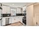 Modern kitchen featuring sleek white cabinets and stainless steel appliances at 175 S Emerson St, Denver, CO 80209