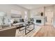 Bright living room features modern decor and a charming brick fireplace at 175 S Emerson St, Denver, CO 80209