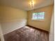 This bedroom has carpeted floors, neutral color walls, a light fixture and a window with a view at 19351 E Purdue Cir, Aurora, CO 80013