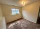 Bedroom featuring carpeted floors, neutral color walls, a light fixture and a window at 19351 E Purdue Cir, Aurora, CO 80013