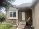 Charming brick home featuring a cozy front porch swing and large window at 19351 E Purdue Cir, Aurora, CO 80013
