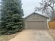 Spacious two-car garage with an extra-long driveway and mature evergreens at 19351 E Purdue Cir, Aurora, CO 80013