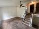 Spacious living room with vaulted ceiling, carpet floor, ceiling fan and staircase at 19351 E Purdue Cir, Aurora, CO 80013