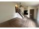 Open-concept living room with carpet, vaulted ceiling, ceiling fan and adjacent staircase at 19351 E Purdue Cir, Aurora, CO 80013