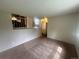 Open living room showcasing neutral walls, carpeted floors and an opening to a loft area at 19351 E Purdue Cir, Aurora, CO 80013
